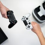 person holding white and black xbox one game controller